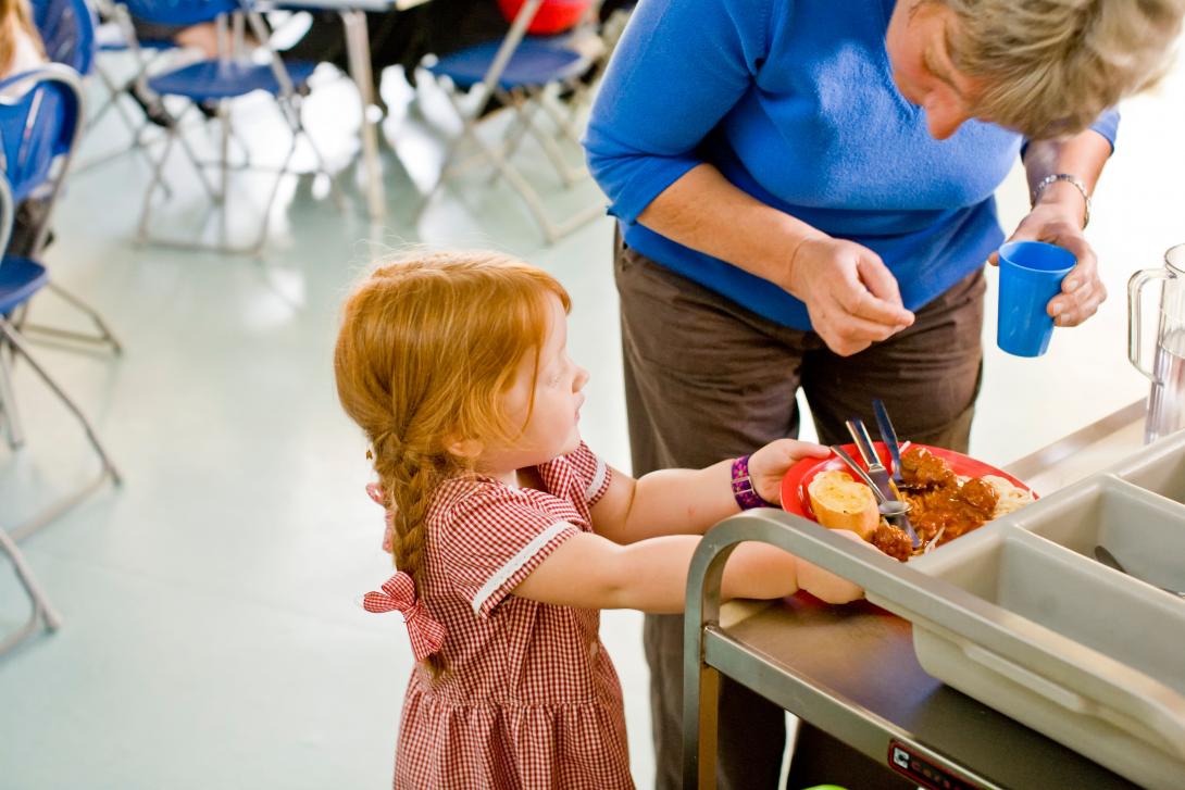A child enjoying a Free School Meal